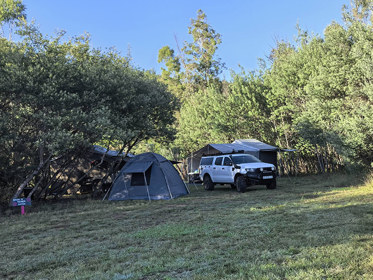 Camp 8 • Breath of Heaven - Tent and vehicle pitched in the clearing