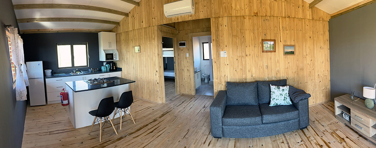 2-Bedroom Riverside Cabin 9: Ravah - Timber-lined lounge and kitchen