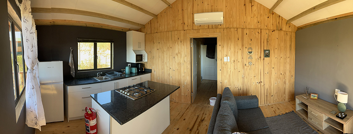 1-Bedroom Riverside Cabin 5: Menucha - Open-plan living area and kitchen