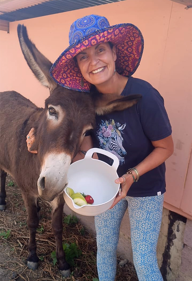 Donna sharing a joyful moment with a donkey