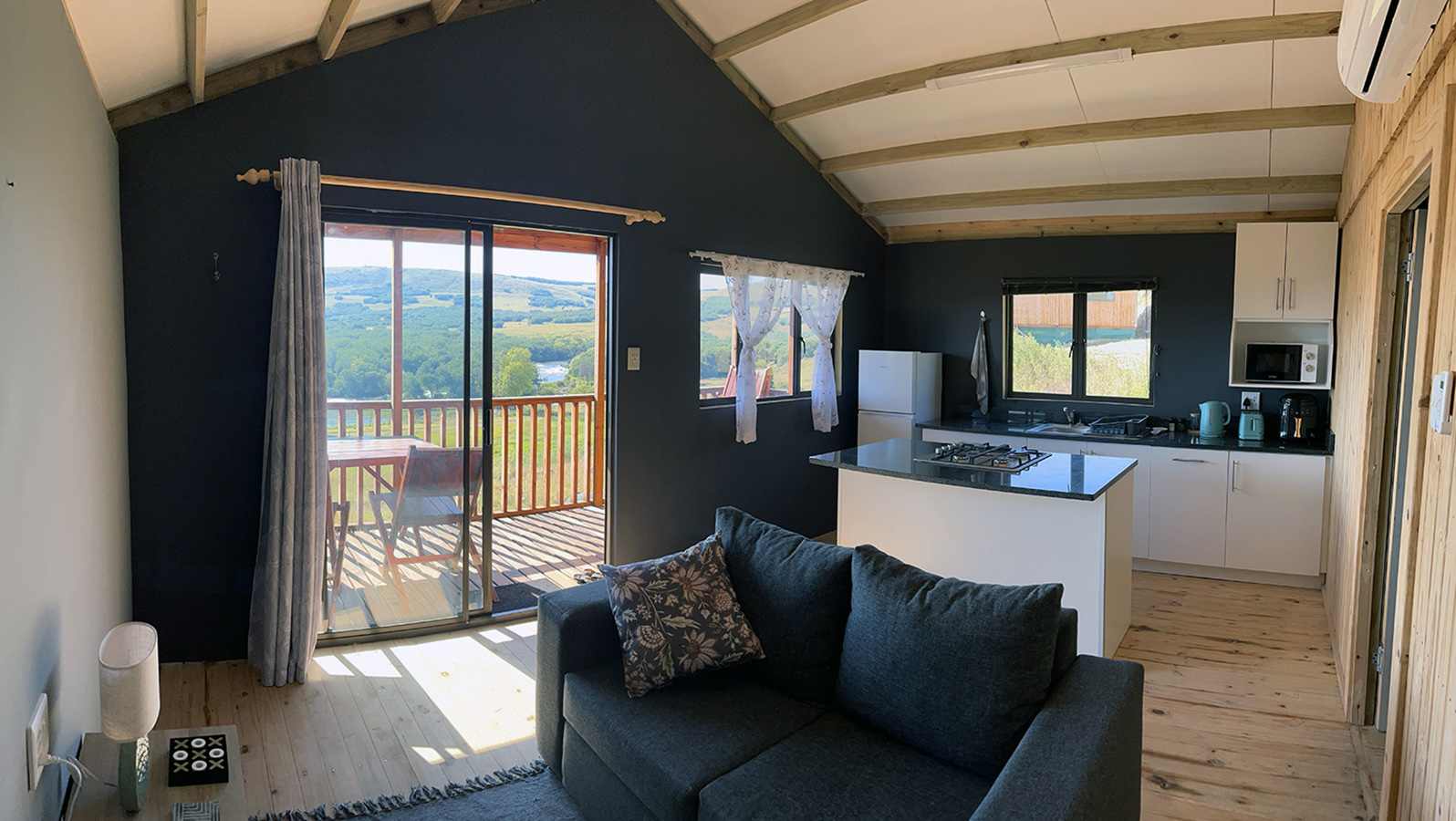 1-Bedroom Pet-Friendly Riverside Cabin 2: Selah - Open-plan living area and kitchen