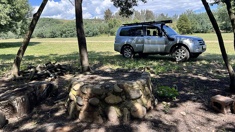 Camp 4 • Open Sky - Stone fire pit with space to park