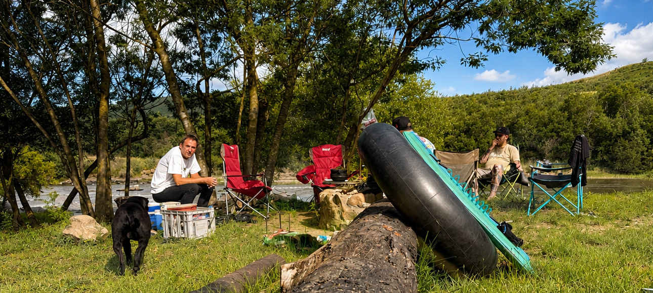 Riverside camp gathering under the trees